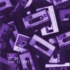 a pile of cassettes sitting next to each other on top of a purple background