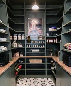 an organized pantry with lots of shelves and drawers