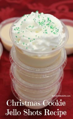 a stack of plastic cups filled with whipped cream and green sprinkles on top