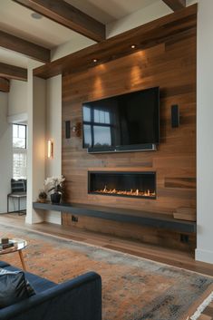 a living room with a fireplace and television mounted on the wall