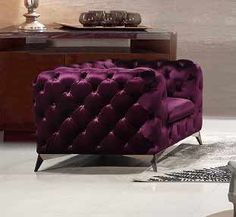 two purple chairs sitting next to each other in a living room