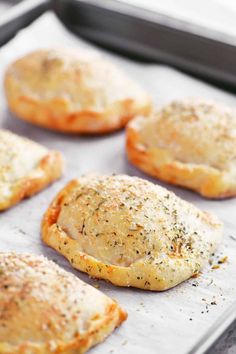 baked pastries sitting on top of a baking sheet