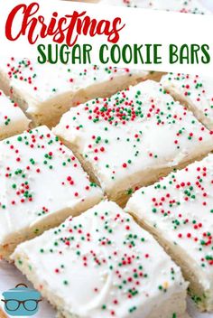 christmas sugar cookie bars with white frosting and sprinkles on a plate