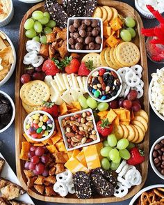 a wooden platter filled with different types of snacks