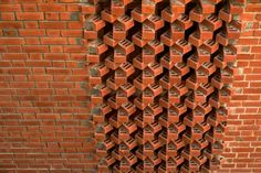 a red brick wall that has been made into a pattern in the shape of cubes