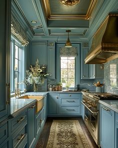 a kitchen with blue cabinets and gold trimmings on the ceiling is pictured in this image