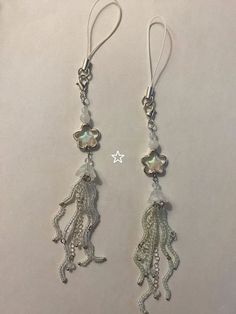 the earrings are made out of silver wire and have dangling beads with charms on them