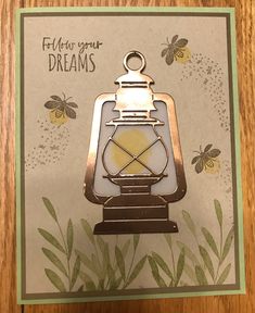 a card with a lantern and bees on it