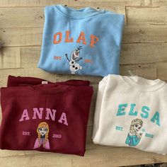 Elevate your style with our Elsa – Anna – Olaf Embroidered Sweatshirt! This trendy crewneck is the perfect gift for