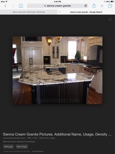 an image of a kitchen with white cabinets and granite counter tops on the website page