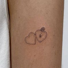 a couple of hearts tattoo on the arm