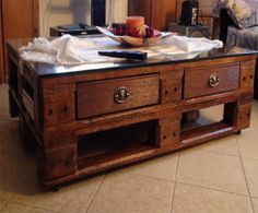 a coffee table made out of pallet wood with drawers on the bottom and one drawer open