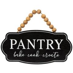 a sign that says pantry on it with some beads hanging from the side of it