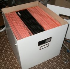 an open file cabinet filled with files on the floor