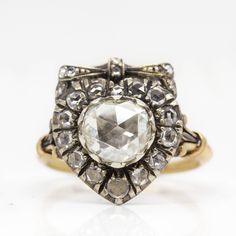 an antique diamond and gold ring, with the center stone surrounded by smaller diamonds on each side