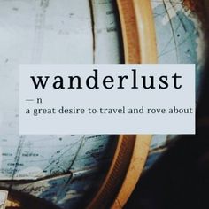 a globe with the words wanderlust on it sitting next to some other items