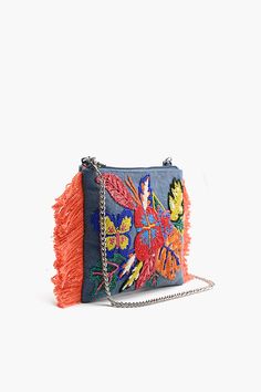 Fringed Clutch with removable crossbody chain Fully Embelished Front, top zip closure Detachable chain linked shoulder strap Top Zip closure & Side fringe details Inside slip pocket and zip pocket with Fully lined interiors Size: 10" x 7.5" Introducing the Rainbow Flutterby Foliage Clutch – a whimsical accessory that adds a burst of color and flair to any ensemble. This fringed clutch is adorned with a fully embellished front, reminiscent of a tropical paradise, making it a statement piece for a Spring Clutch With Zipper Closure, Spring Crossbody Clutch With Chain Strap, Festival Multicolor Embroidered Clutch Bag, Bohemian Multicolor Clutch With Floral Embroidery, Multicolor Fringe Crossbody Bag, Bohemian Multicolor Embellished Clutch, Bohemian Multicolor Embroidery Clutch, Side Fringe, Fringe Clutch