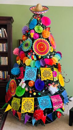 a brightly colored christmas tree decorated with paper fans