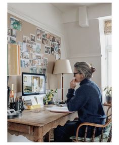 a woman sitting at a desk in front of a computer