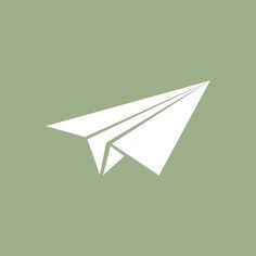 a white paper airplane on a green background