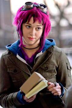 a woman with purple hair is holding a folder