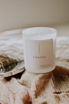 a white candle sitting on top of a wooden table