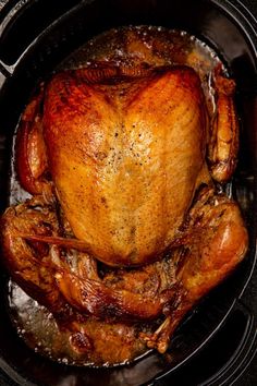 a roasted turkey in a roasting pan