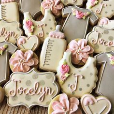 decorated cookies are arranged in the shape of baby's arrivals and their names