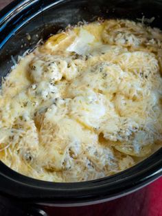 a crock pot filled with food sitting on top of a table