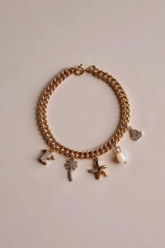 Nautical Gold Filled Charm Bracelet 🐚✨ Custom made to your wrist size so *PLEASE INCLUDE YOUR WRIST SIZE IN THE PERSONALZATION BOX* If you would like to build your own charm bracelet please see my separate listing : Build Your Own Custom Charm Bracelet ✨ 18k Gold Filled Charms included on the bracelet:  * Genuine Shell Pearl * Gold Filled Starfish w/ Swarovski Crystals * Gold Filled Sailboat w/ Swarovski Crystals * Gold Filled Palm Tree w/ Swarovski Crystals * Gold Filled Turtle w/ Swarovski Cr Custom Charm Bracelet, Custom Charms, Jewelry Earrings Hoops, Crystals And Gemstones, Palm Tree, Swarovski Crystal, Swarovski Crystals, Gold Filled, 18k Gold