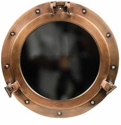 an old brass porthole mirror with rivets