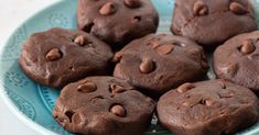 there are chocolate cookies in the blue bowl on the table, ready to be eaten