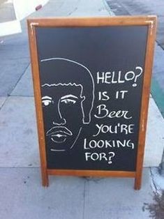 a sign on the sidewalk that says hello is it beer you're looking for?