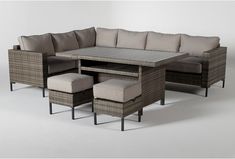 an outdoor sectional set with cushions and footstools