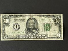 an old one dollar bill with the number fifty on it