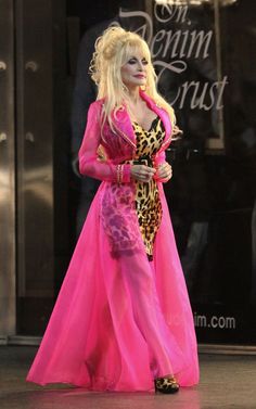 lady in pink and leopard print dress walking down the street with her hair pulled back