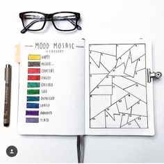 an open notebook with glasses on top of it