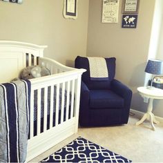 a baby's room with a blue chair and white crib