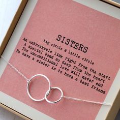 a box with a necklace in it and a poem on the inside that says sisters