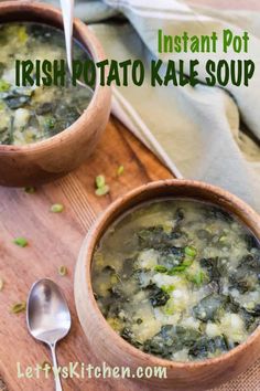 two bowls of irish potato kale soup on a wooden cutting board with spoons