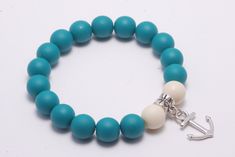 turquoise color and white 12 mm bead stretch bracelet with hanging silver anchor charm. New, handmade adjustable on wrist. Blue Casual Jewelry With 8mm Beads, Casual Turquoise Beaded Jewelry, Casual Blue Hypoallergenic Jewelry, Everyday Blue Jewelry With 8mm Beads, Nickel Free Casual Round Bead Jewelry, Casual Hypoallergenic Round Beads Jewelry, Casual Hypoallergenic Jewelry With Round Beads, Casual Blue Charm Bracelet With Round Beads, Casual Nickel-free Round Beaded Jewelry