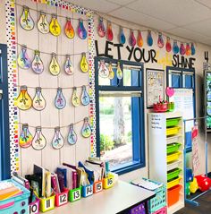 a classroom with lots of colorful items on the wall and bulletin boards attached to the walls