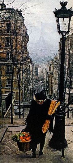 an old woman is picking carrots from the street in front of the eiffel tower