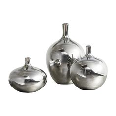 three silver vases sitting next to each other