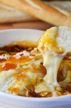 a white bowl filled with cheesy bread and cheese