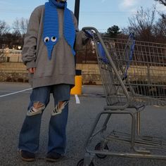 a person standing next to a shopping cart