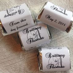 four rolls of wedding candy with the names of their bride and grooms on them