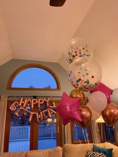 balloons and streamers are hanging from the ceiling