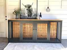 a cow is on top of a black cabinet