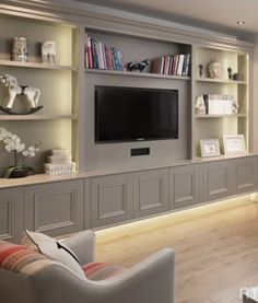 a living room filled with furniture and a flat screen tv mounted on a wall next to a fire place